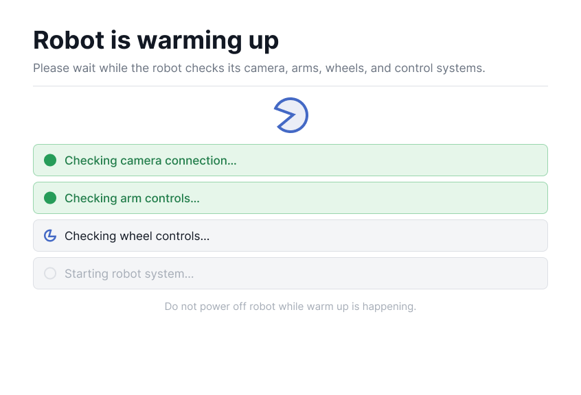 Boot-up screen checking the camera connection, arm controls, wheel controls, and robot system one at a time, with a warning not to power off during warm-up.